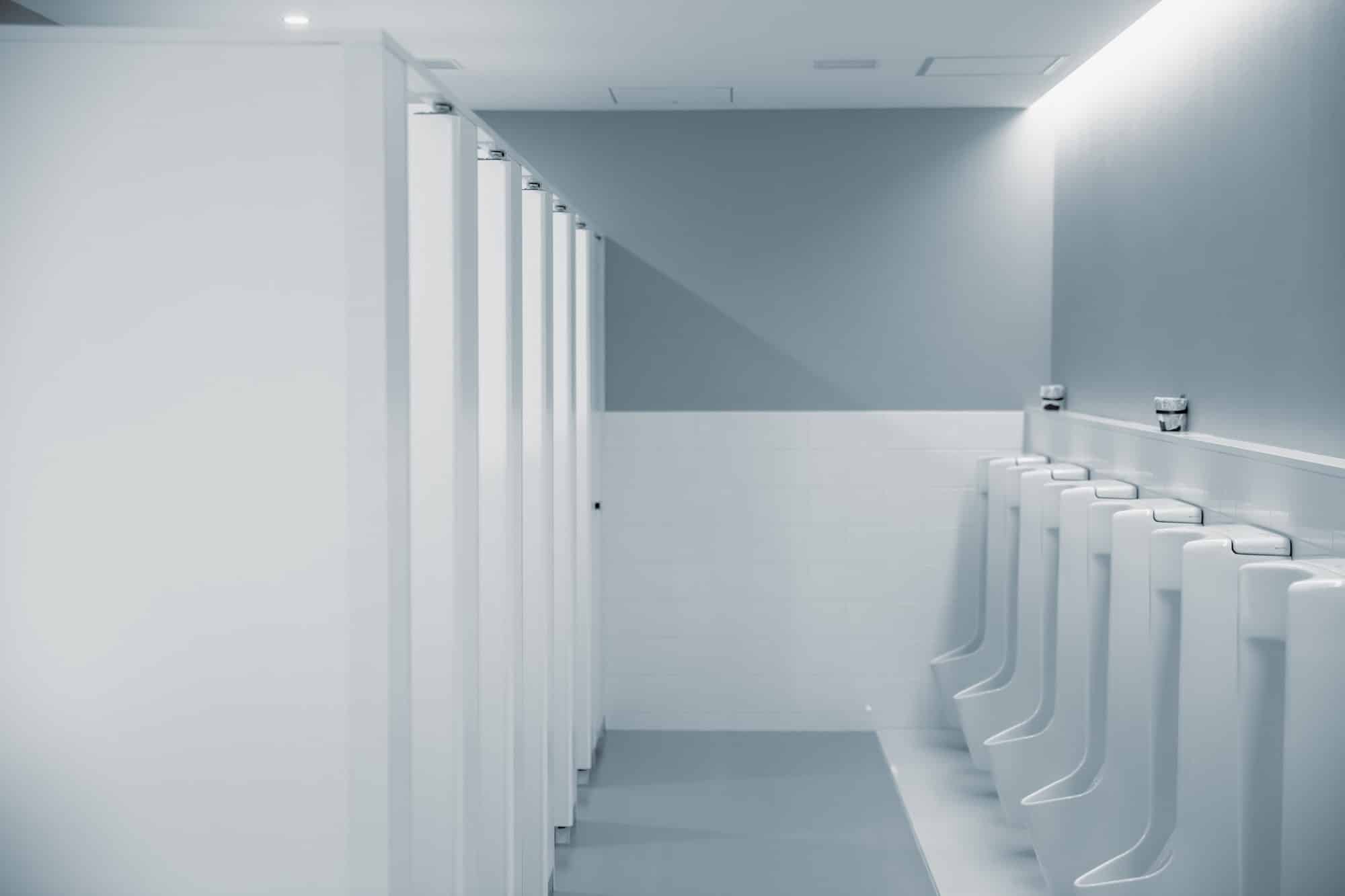men restroom with row of urinal bowl clean modern style public toilet in office interior